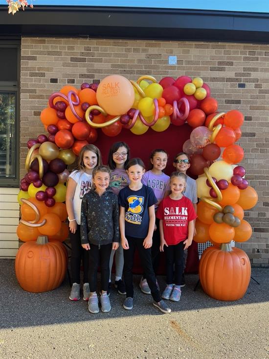 Students in front of fall balloon arch